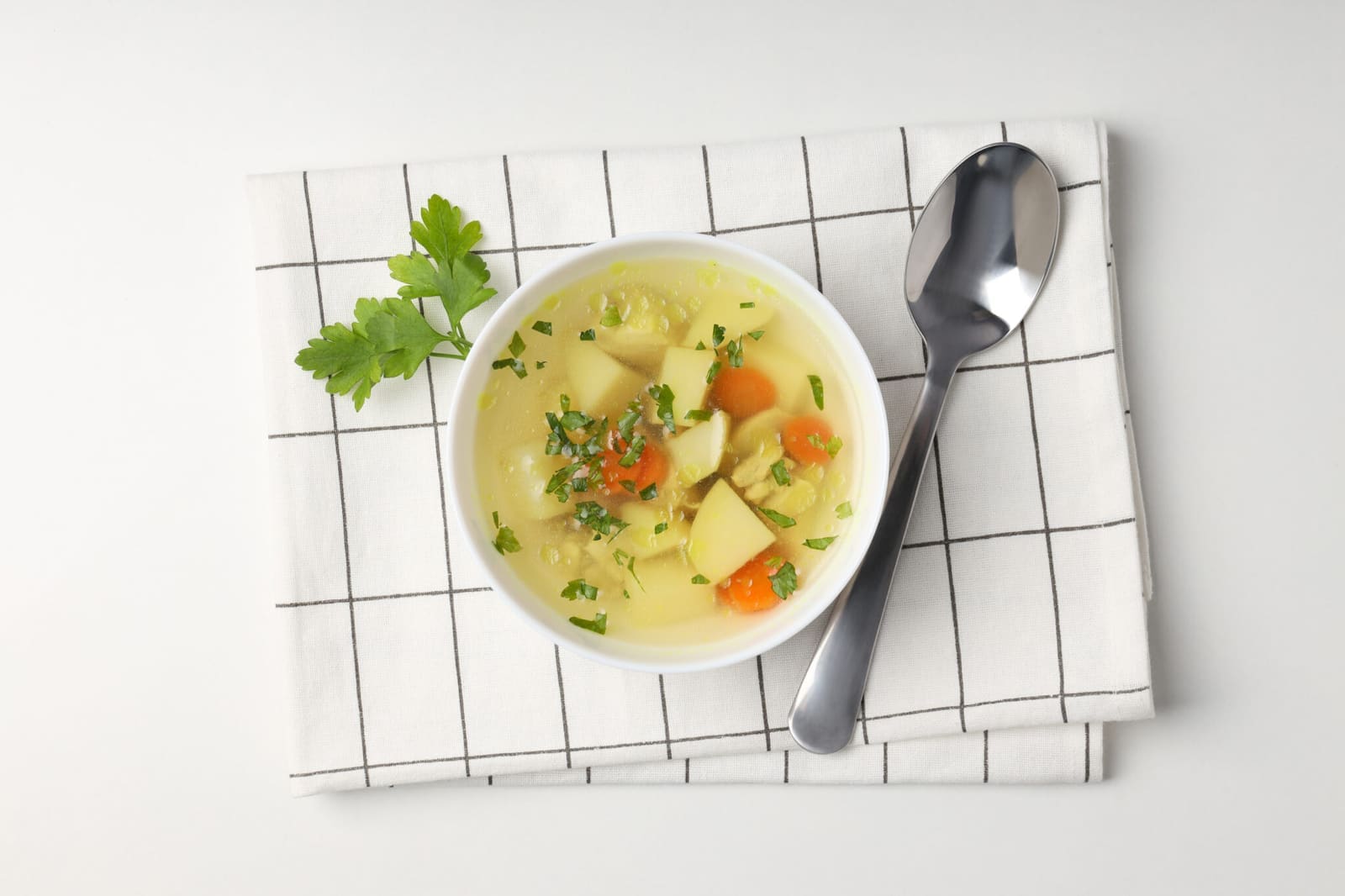 Chicken soup on white background, top view